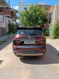 Burgundy Red MG Hector Plus Sharp Petrol Hybrid 6 Seater