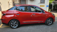 Fiery Red Hyundai Aura 1.2L Kappa Petrol AMT SX Plus