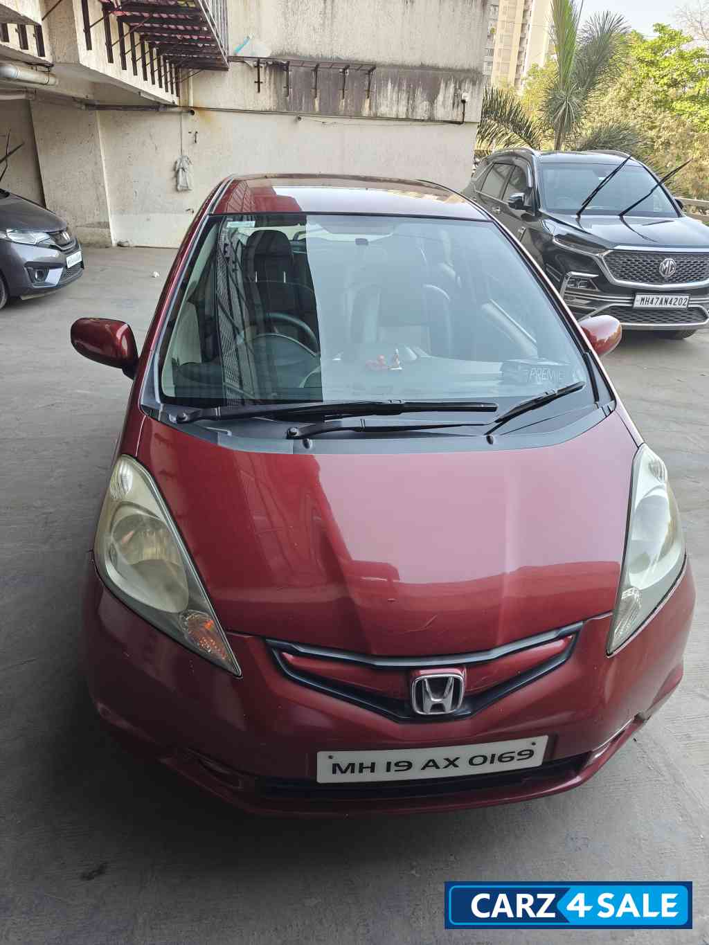 Maroon Honda Jazz Active