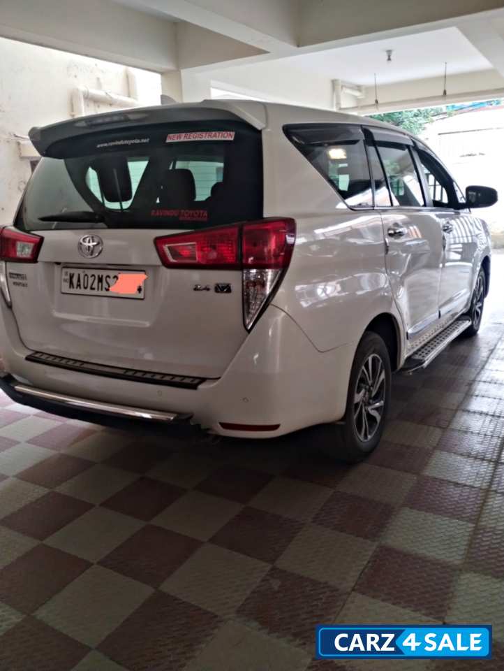 White Toyota Innova Crysta
