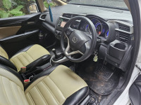 White Honda Jazz 1.2 L petrol