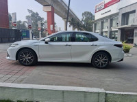 White Toyota Camry Hybrid